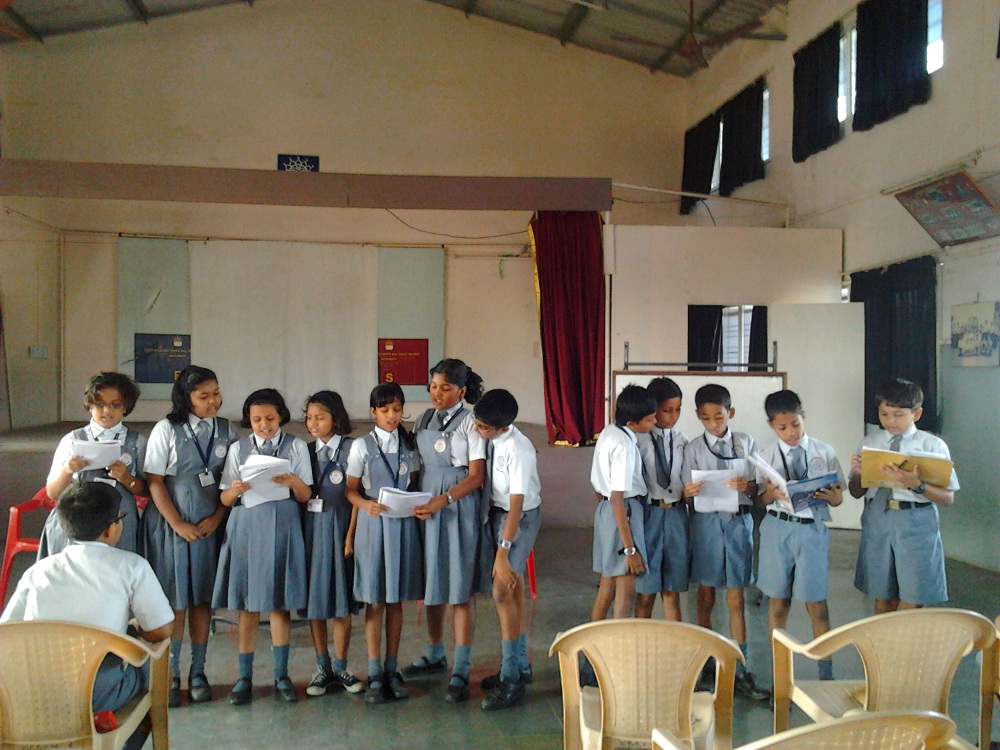 Children in uniform reading from books