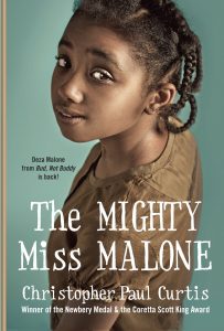 Text: Deza Malone from 'Bud, Not Buddy' is back!
The Mighty Miss Malone
Christopher Paul Curtis
Winner of the Newbery Medal & the Coretta Scott King Award
Image: Photograph of a girl looking upwards into the camera, a slight smile on her face