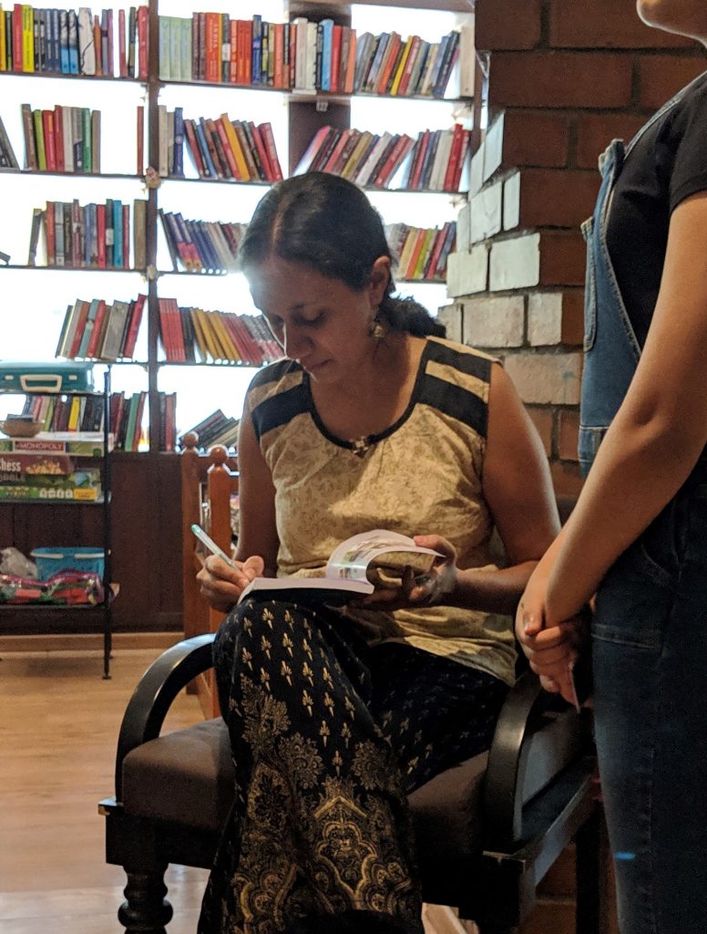 Varsha Seshan signing a copy of The Prophecy of Rasphora at Atta Galatta