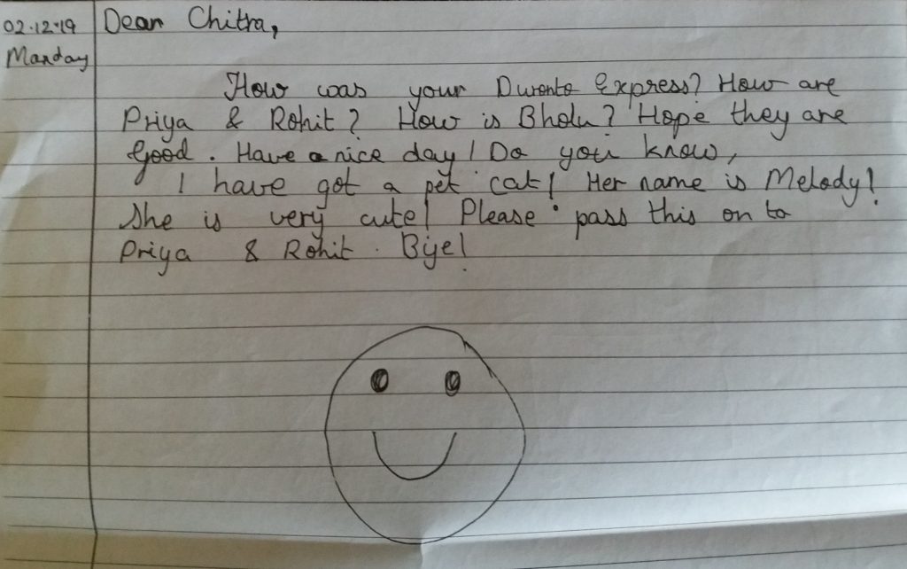 A handwritten note, ending with a big happy emoji
Text:
02.12.19 Monday
Dear Chitra,
How was your Duronto Express? How are Priya & Rohit? How is Bholu? Hope they are Good. Have a nice day! Do you know, I have got a pet cat! Her name is Melody! She is very cute! Please pass this on to Priya & Rohit. Bye!