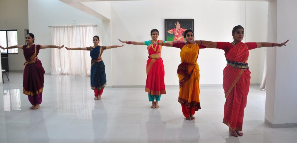 Five girls in practice costumes with their hands in naatyarambham position