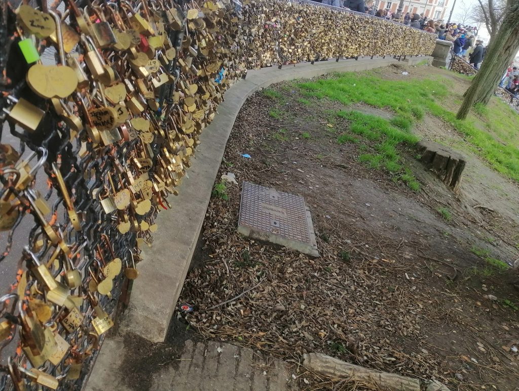 Thousands of golden locks on a curving fence