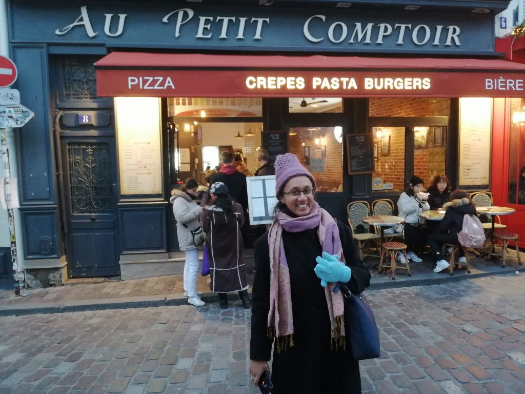 Varsha Seshan outside a cafe, Au Petit Comptoir