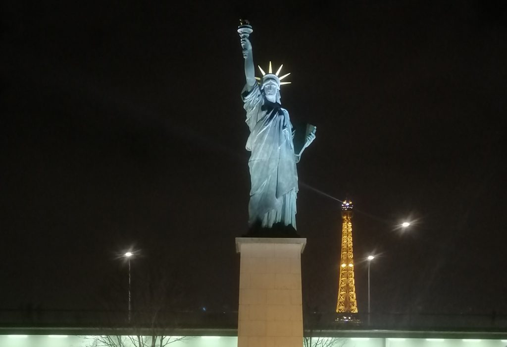 The Statue of Liberty with the Eiffel Tower in the background