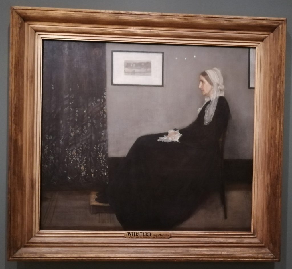 A painting of a woman dressed in black sitting with her left profile towards us