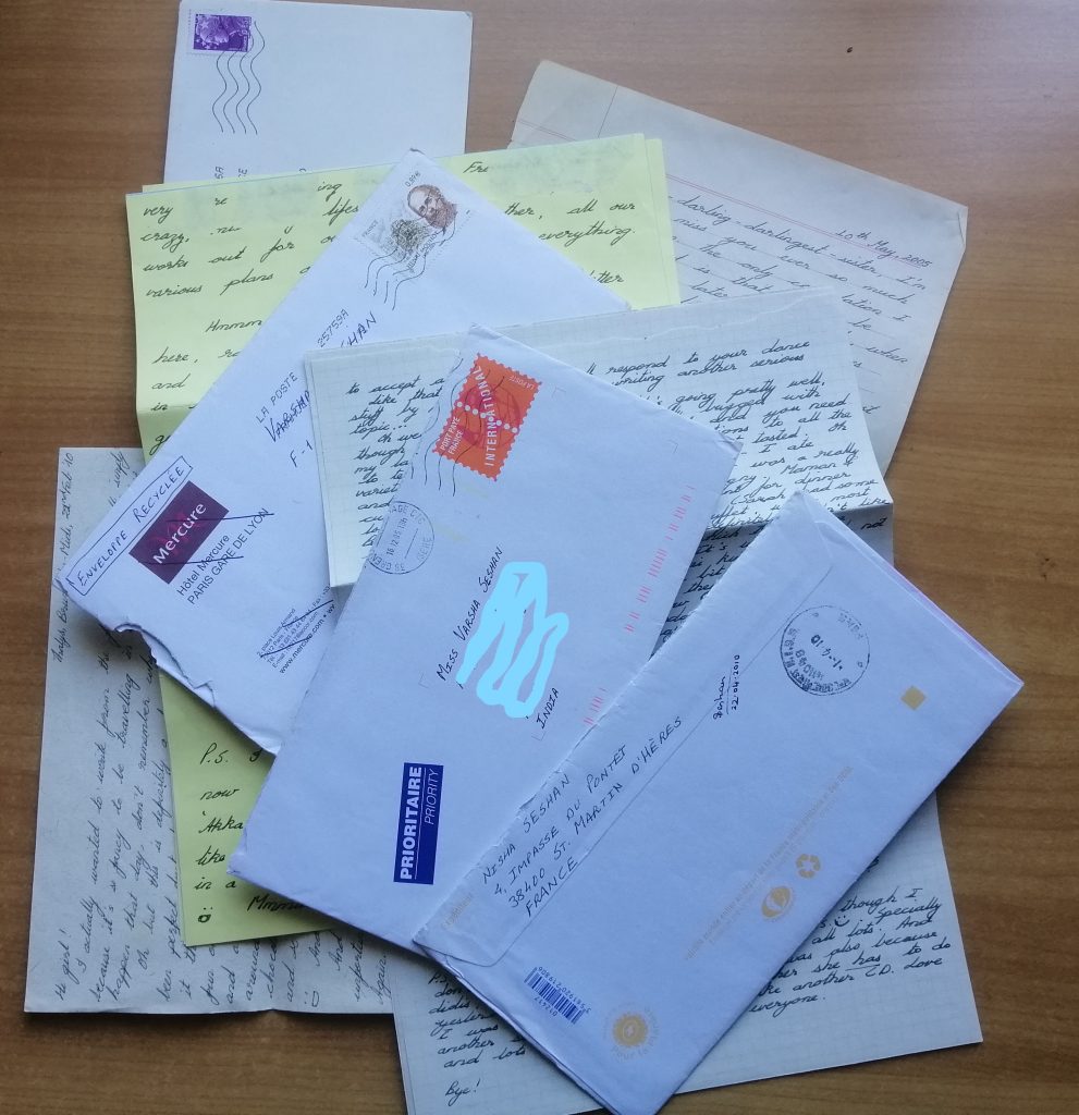 A pile of handwritten letters and envelopes.