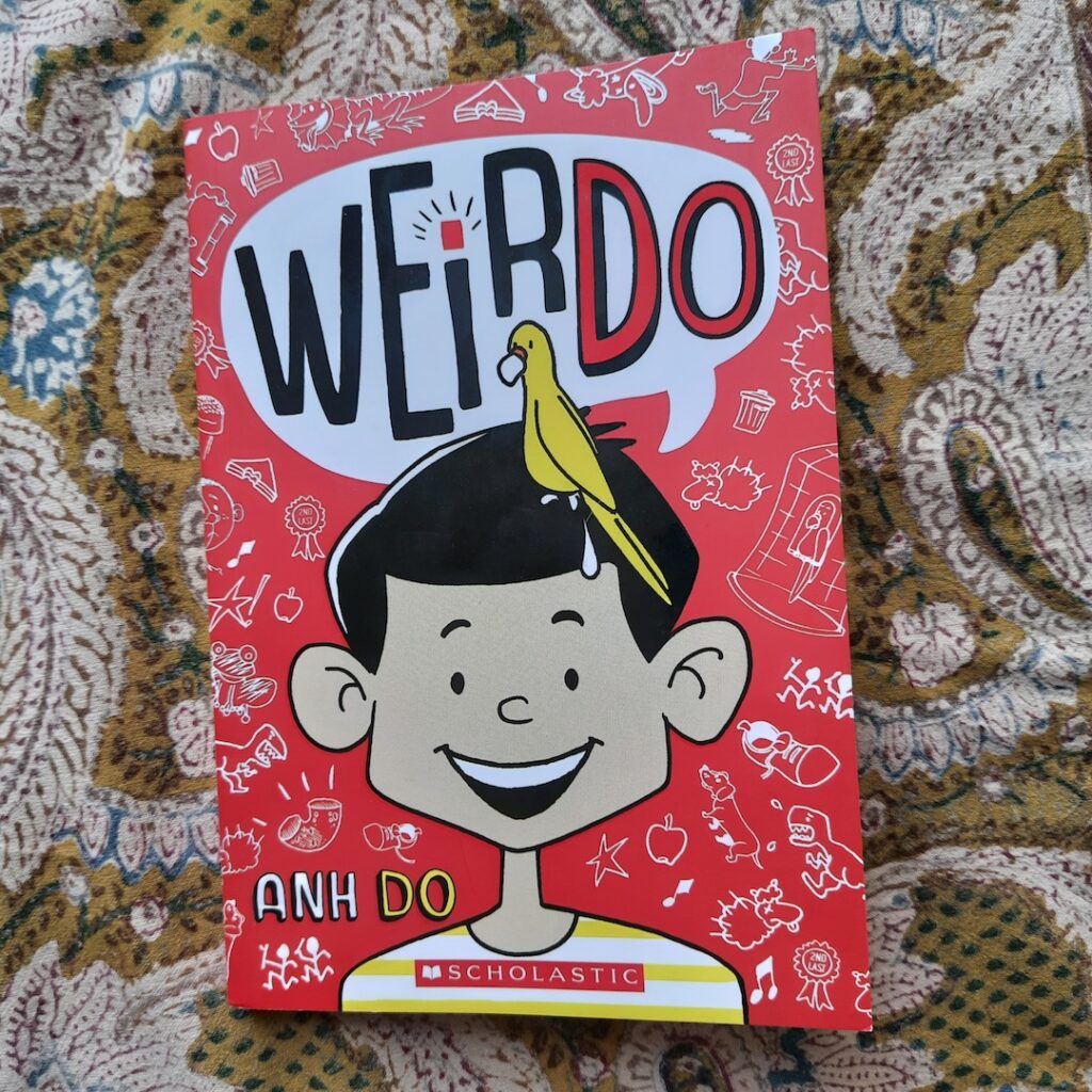 A book on a cushion
Book cover text:WeirDo
Anh Do
Scholastic
Image: Illustration of a boy with a pooping parrot on his head